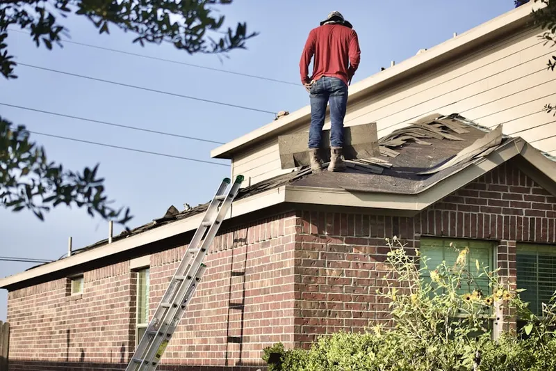 Professional roofer working on a residential roof in Front Royal Junction